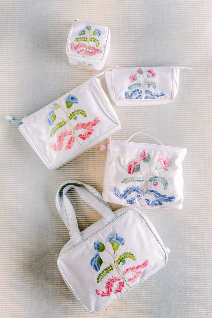 Pink-trimmed Carnation travel bags arranged in a row by Lenora
