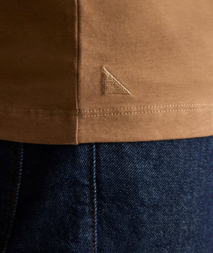 Model is wearing UNTUCKit EcoSoft Short-Sleeve Henley in toasted coconut.