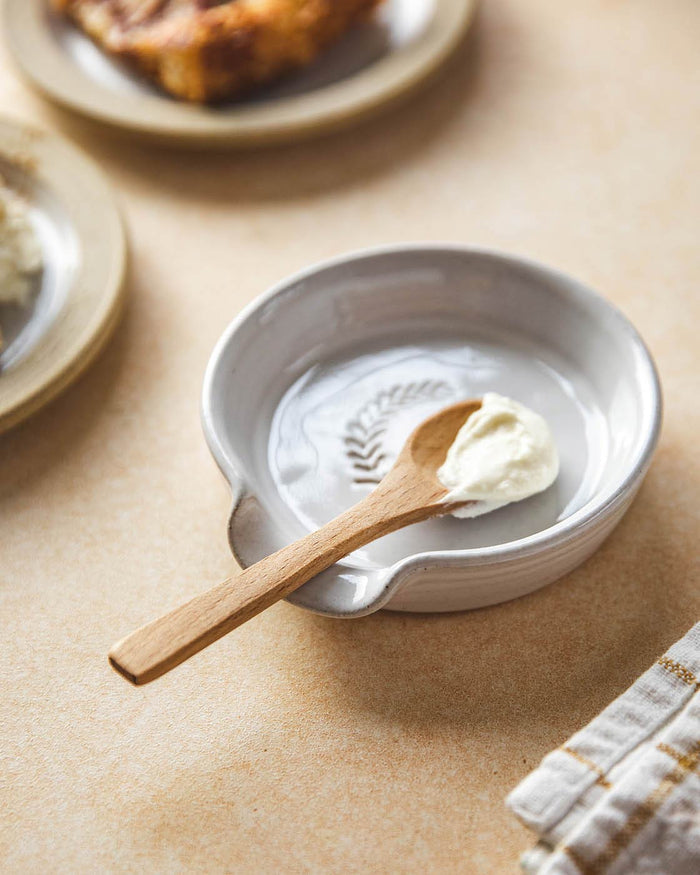 Laurel Stoneware Spoon Rest — wooden spoon resting in the glazed dish; Farmhouse Pottery