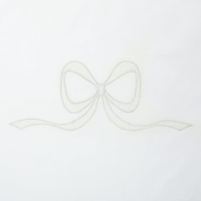 Close view of ivory Lucy bow appliqué on white cotton by Lenora