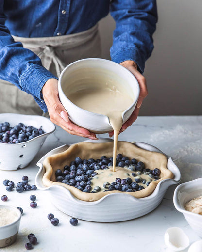 Pantry Stoneware Mixing Bowl — pouring batter into a fruit-filled pie dish; Farmhouse Pottery