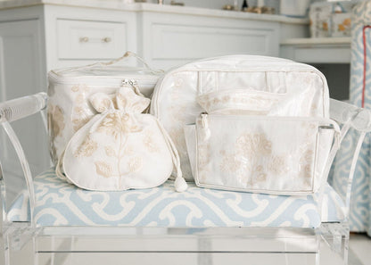 Peony travel bags and jewelry pouch arranged together on a tray by Lenora